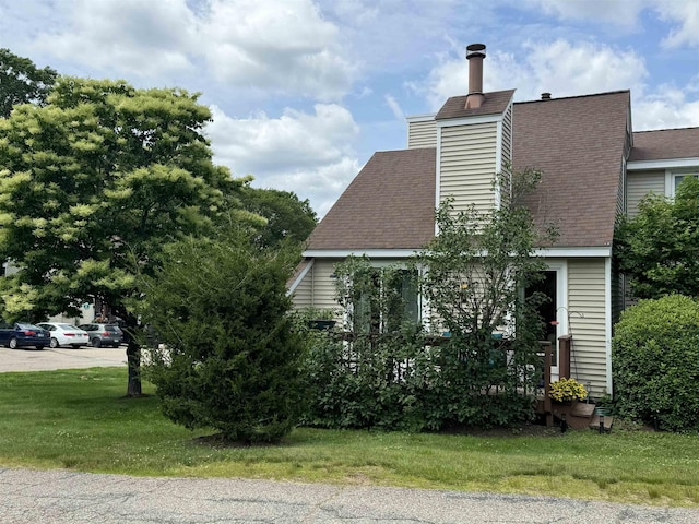 501 Bean Hill Rd Unit 32, Northfield, NH 03276 - view of home's exterior with a shingled roof and a lawn