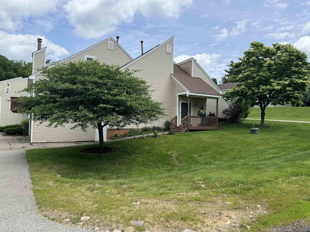501 Bean Hill Rd Unit 32, Northfield, NH 03276 - view of side of home featuring a yard and a deck