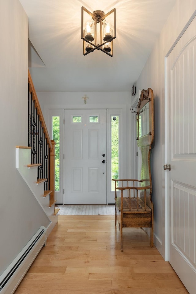 52 Jeffrey Dr, Sunapee, NH 03782 - foyer with a baseboard radiator, light wood-type flooring, stairs, and a chandelier