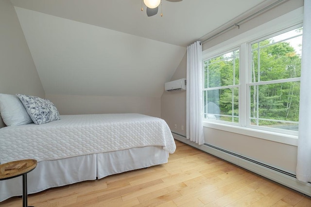 52 Jeffrey Dr, Sunapee, NH 03782 - bedroom with a baseboard heating unit, an AC wall unit, light wood-style floors, lofted ceiling, and a ceiling fan