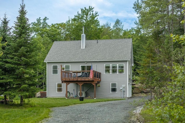 52 Jeffrey Dr, Sunapee, NH 03782 - back of house with a deck, a yard, a chimney, a shingled roof, and asphalt driveway
