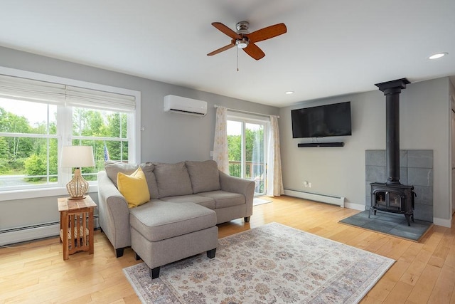 52 Jeffrey Dr, Sunapee, NH 03782 - living area with a wall unit AC, a baseboard radiator, ceiling fan, light wood-type flooring, and recessed lighting