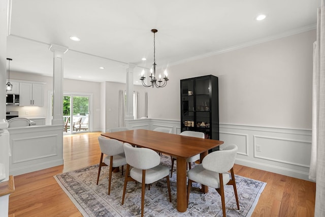9 Bonanno Rd, Salem, NH 03079 - dining room with ornate columns, light wood-style floors, wainscoting, a decorative wall, and recessed lighting