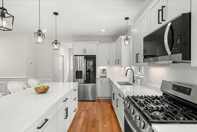 9 Bonanno Rd, Salem, NH 03079 - kitchen featuring appliances with stainless steel finishes, recessed lighting, white cabinets, light stone counters, and wainscoting