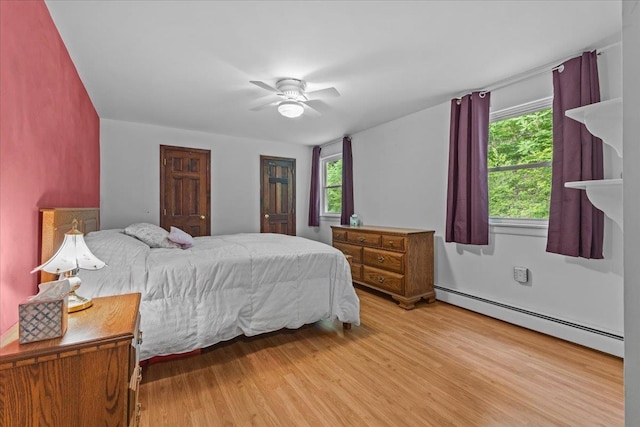 89 Catella Rd, Essex, VT 05452 - bedroom featuring a baseboard heating unit, light wood-style flooring, and a ceiling fan