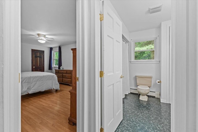 89 Catella Rd, Essex, VT 05452 - bedroom featuring multiple windows, a baseboard heating unit, and a ceiling fan