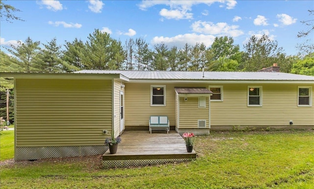 89 Catella Rd, Essex, VT 05452 - rear view of property with a deck, a yard, and a metal roof