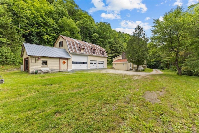 89 Catella Rd, Essex, VT 05452 - view of front of home featuring a gambrel roof, a detached garage, a metal roof, an outdoor structure, and a front yard