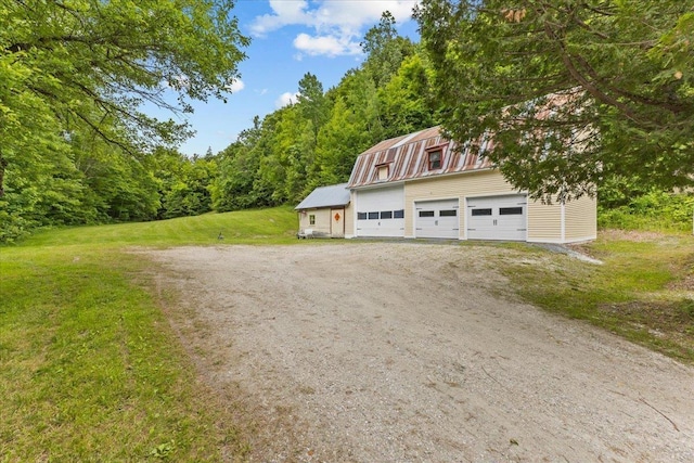 89 Catella Rd, Essex, VT 05452 - view of property exterior featuring an outbuilding, a detached garage, a barn, a yard, and a wooded view