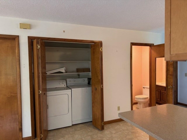 122 Batchelder St Unit A-8, Barre City, VT 05641 - laundry area with washer and clothes dryer, a textured ceiling, and light floors