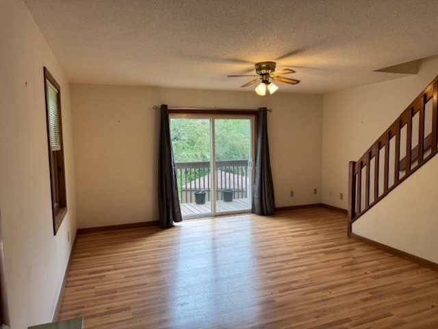 122 Batchelder St Unit A-8, Barre City, VT 05641 - empty room with stairway, wood finished floors, ceiling fan, and a textured ceiling