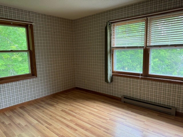 122 Batchelder St Unit A-8, Barre City, VT 05641 - spare room with a baseboard heating unit, wood finished floors, and healthy amount of natural light