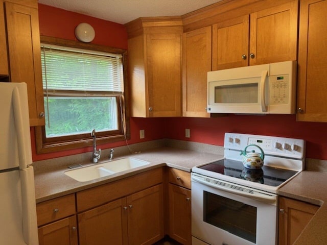122 Batchelder St Unit A-8, Barre City, VT 05641 - kitchen featuring white appliances, brown cabinetry, and light countertops
