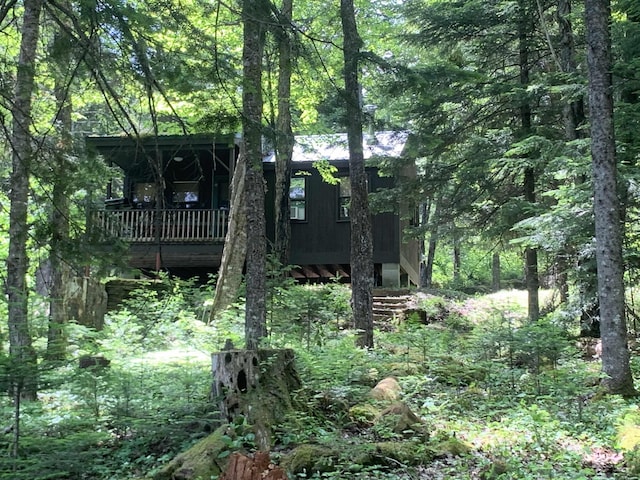 505 River Rd, Pittsburg, NH 03592 - back of property with a view of trees and a deck