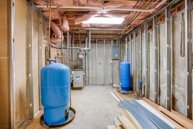 945 Mason Rd, Wilton, NH 03086 - unfinished below grade area featuring a water pressure tank, electric panel, and a heating unit