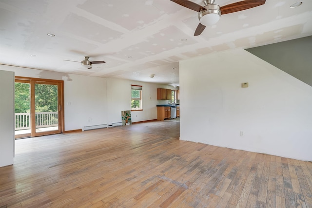945 Mason Rd, Wilton, NH 03086 - unfurnished living room featuring a ceiling fan, light wood finished floors, and healthy amount of natural light
