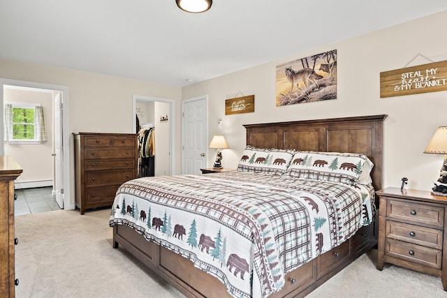 121 Deer Run Rd, Middleton, NH 03887 - bedroom featuring a baseboard heating unit, light colored carpet, ensuite bathroom, a spacious closet, and a closet