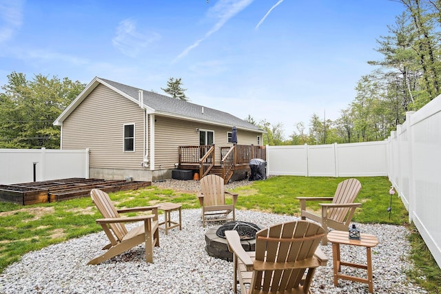 121 Deer Run Rd, Middleton, NH 03887 - rear view of property with an outdoor fire pit, a fenced backyard, and a wooden deck