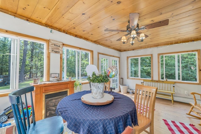 73 Tall Pine Rd, Farmington, NH 03835 - dining space featuring wood finished floors, wooden ceiling, a ceiling fan, baseboard heating, and a glass covered fireplace