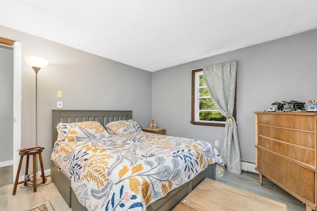 73 Tall Pine Rd, Farmington, NH 03835 - bedroom featuring wood finished floors and a baseboard heating unit