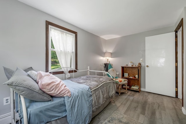 73 Tall Pine Rd, Farmington, NH 03835 - bedroom featuring wood finished floors and a baseboard radiator
