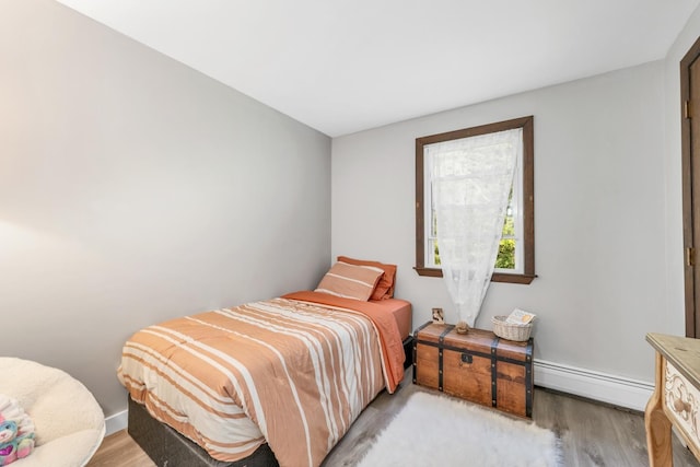 73 Tall Pine Rd, Farmington, NH 03835 - bedroom with baseboard heating and light wood-style floors