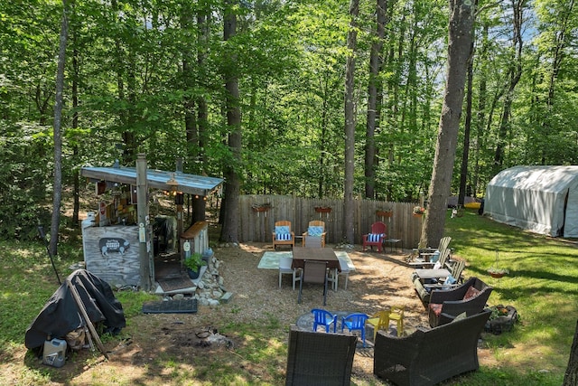 73 Tall Pine Rd, Farmington, NH 03835 - view of yard with a forest view, an outdoor fire pit, and an outdoor structure