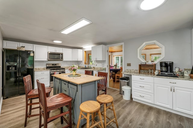 73 Tall Pine Rd, Farmington, NH 03835 - kitchen featuring appliances with stainless steel finishes, wooden counters, white cabinetry, and light wood finished floors