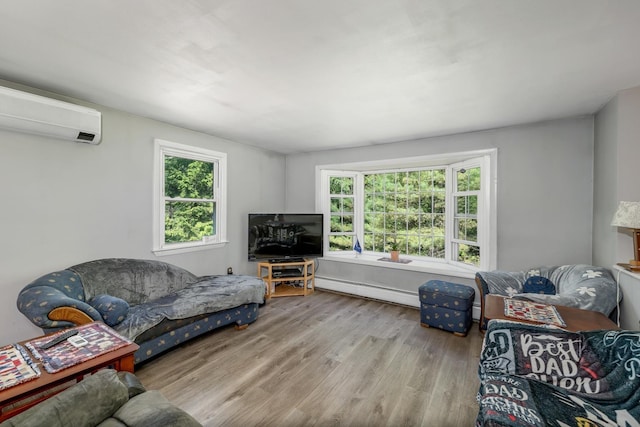 73 Tall Pine Rd, Farmington, NH 03835 - living area featuring wood finished floors, a baseboard heating unit, healthy amount of natural light, and a wall mounted AC
