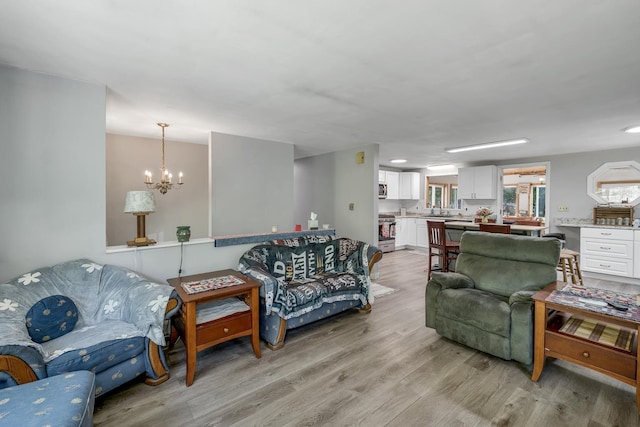73 Tall Pine Rd, Farmington, NH 03835 - living area featuring a chandelier and light wood finished floors
