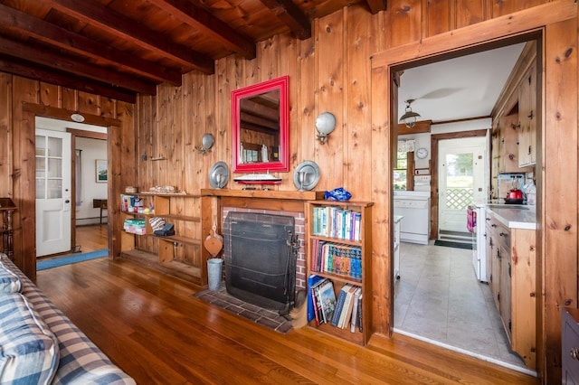 26 Colony Cove Rd, Durham, NH 03824 - living area featuring wood walls, a wood stove, a wooden ceiling with exposed beams, and wood finished floors