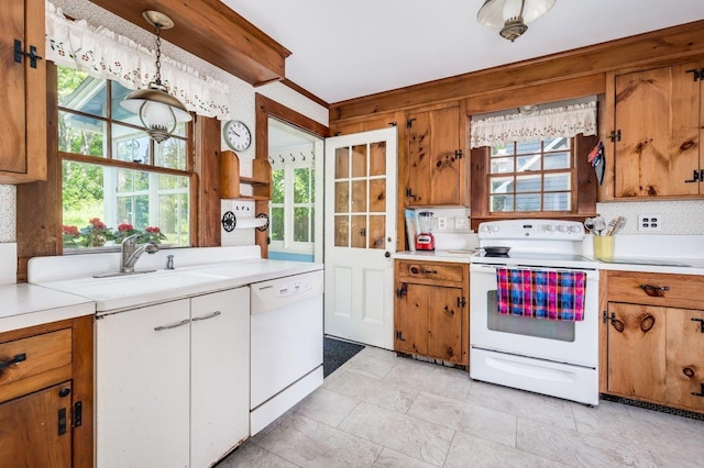 26 Colony Cove Rd, Durham, NH 03824 - kitchen featuring white appliances, light countertops, brown cabinetry, and hanging light fixtures