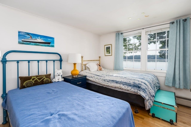 26 Colony Cove Rd, Durham, NH 03824 - bedroom with wood finished floors, baseboard heating, and a water view