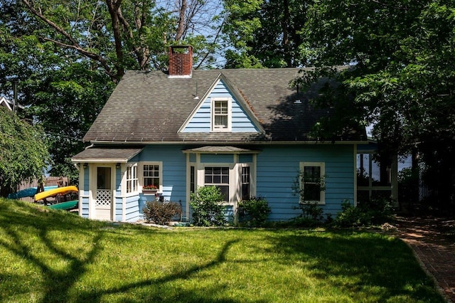 26 Colony Cove Rd, Durham, NH 03824 - view of front of house featuring a chimney, a front lawn, and roof with shingles