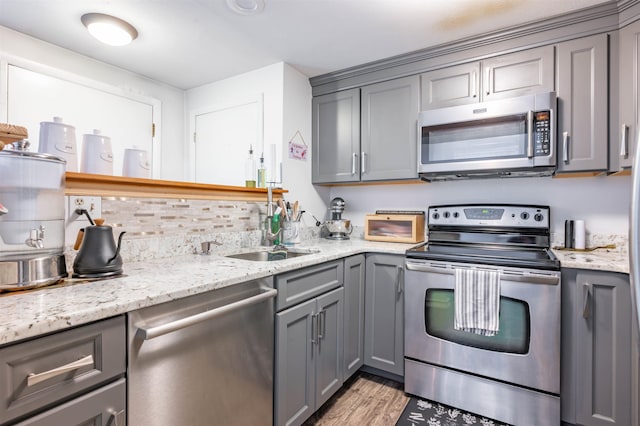 1 Harwich Ct, Merrimack, NH 03054 - kitchen featuring stainless steel appliances, gray cabinetry, light wood finished floors, and light stone counters
