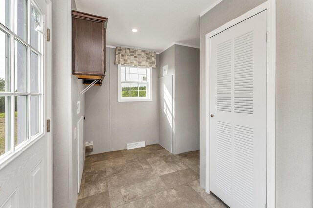 106 Stevens Rd Unit 1, Effingham, NH 03882 - laundry area featuring stone finish flooring, ornamental molding, cabinet space, and recessed lighting