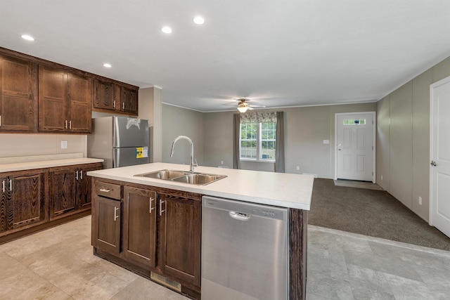 106 Stevens Rd Unit 1, Effingham, NH 03882 - kitchen featuring appliances with stainless steel finishes, ceiling fan, light countertops, dark brown cabinetry, and a kitchen island with sink