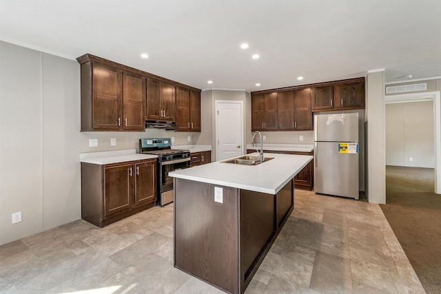 106 Stevens Rd Unit 1, Effingham, NH 03882 - kitchen with appliances with stainless steel finishes, dark brown cabinetry, light countertops, recessed lighting, and a center island with sink