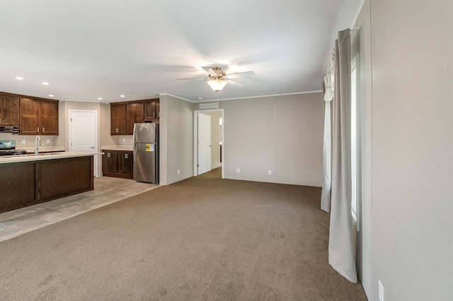 106 Stevens Rd Unit 1, Effingham, NH 03882 - kitchen featuring stainless steel appliances, ceiling fan, light countertops, light carpet, and recessed lighting