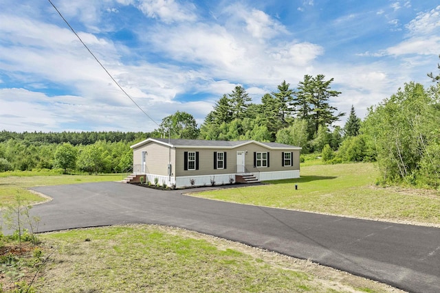 106 Stevens Rd Unit 1, Effingham, NH 03882 - manufactured / mobile home featuring a wooded view, driveway, and a front yard