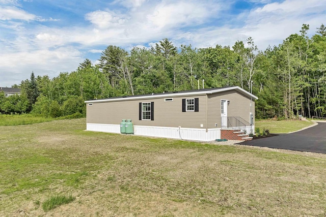 106 Stevens Rd Unit 1, Effingham, NH 03882 - view of home's exterior with a yard and a view of trees