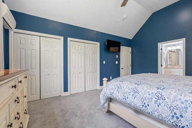 65 Forest St, Londonderry, NH 03053 - carpeted bedroom with an AC wall unit, two closets, lofted ceiling, ceiling fan, and ensuite bathroom