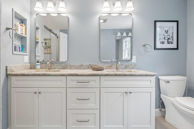 65 Forest St, Londonderry, NH 03053 - bathroom with a tile shower, double vanity, and tile patterned floors