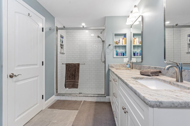 65 Forest St, Londonderry, NH 03053 - full bath with a stall shower, double vanity, tile patterned flooring, and recessed lighting