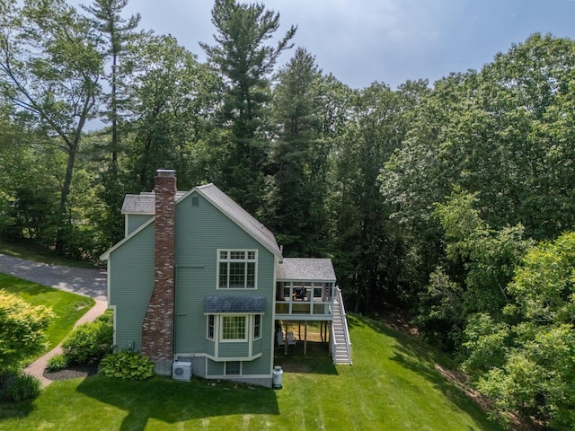 65 Forest St, Londonderry, NH 03053 - rear view of property with stairway, a chimney, a deck, a lawn, and a view of trees