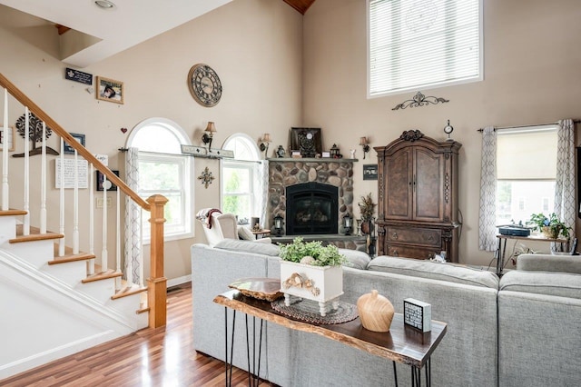 57 Rutland St, Dover, NH 03820 - living area featuring a high ceiling, wood finished floors, stairs, and a fireplace
