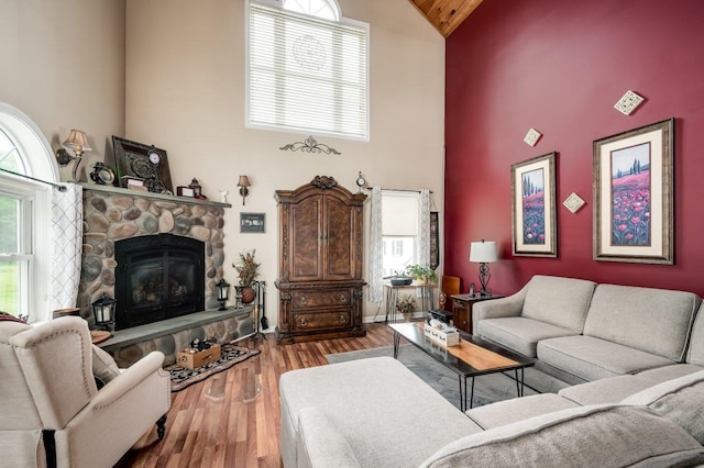 57 Rutland St, Dover, NH 03820 - living room featuring high vaulted ceiling, a fireplace, wood finished floors, and healthy amount of natural light