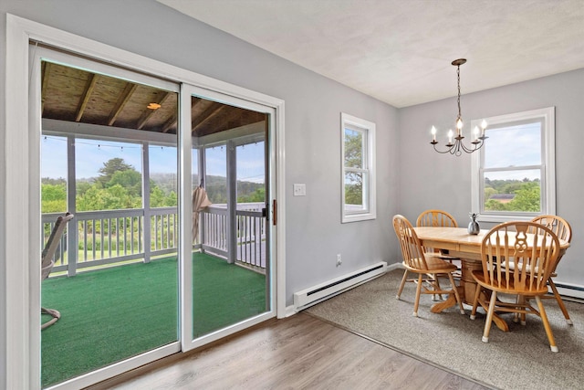 261 Main Ave, South Hampton, NH 03827 - dining space featuring baseboard heating, wood finished floors, and a chandelier