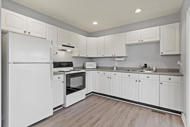 261 Main Ave, South Hampton, NH 03827 - kitchen with white appliances, under cabinet range hood, white cabinetry, recessed lighting, and light wood-style flooring
