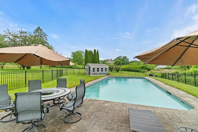 261 Main Ave, South Hampton, NH 03827 - view of swimming pool featuring a patio, outdoor dining space, a fenced backyard, and an outdoor structure